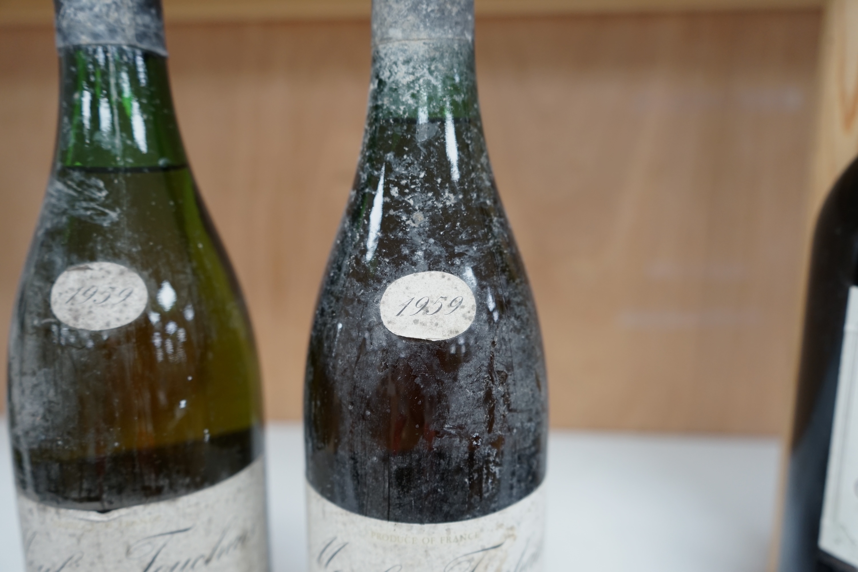 Two bottles of Moulin Touchais Anjou 1959 red wine. Condition - fair, staining to label, etc.